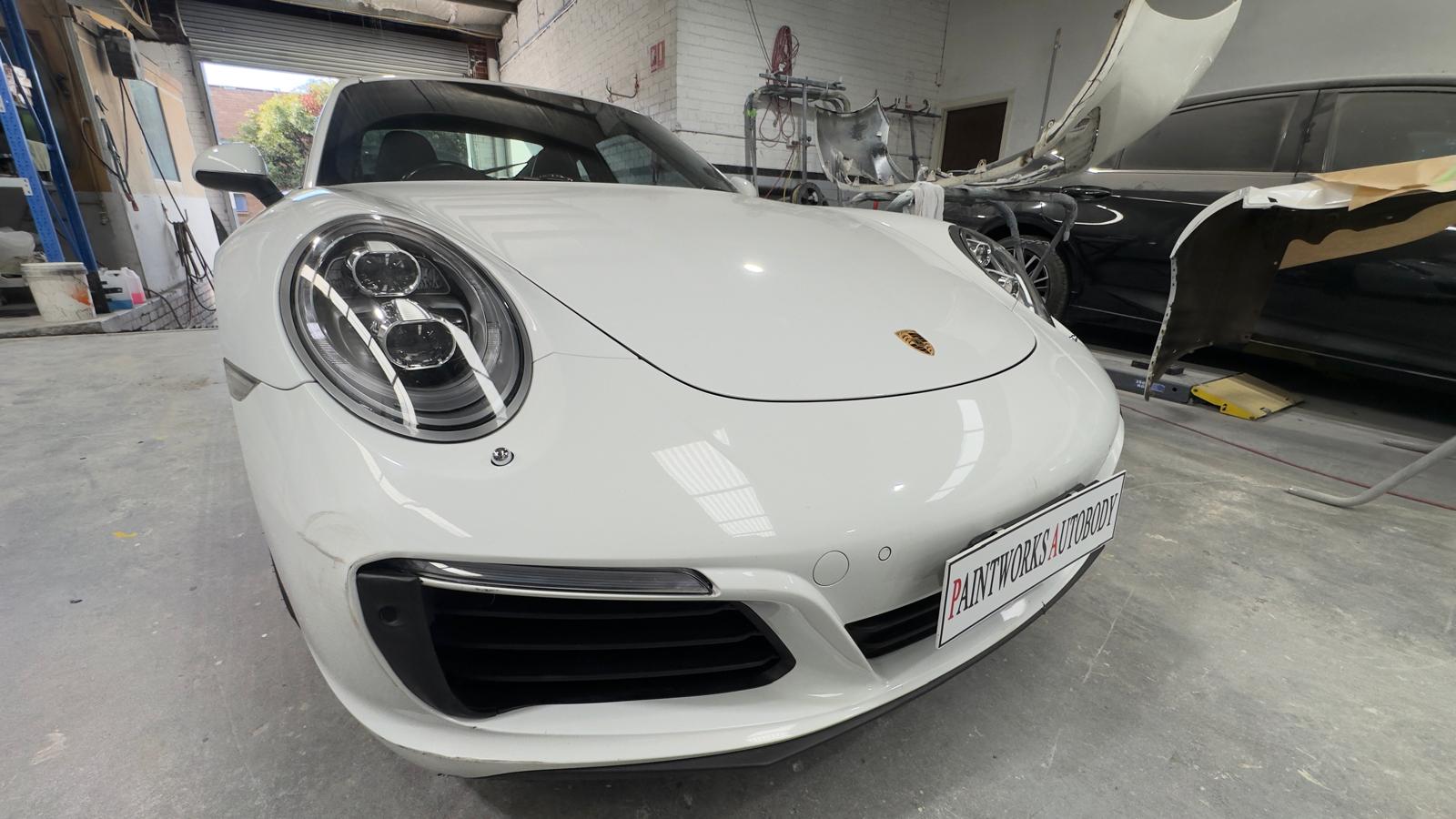 Before: white Porsche 911 front bumper scuffs and paint damage at Paintworks Autobody Melbourne